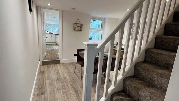 A staircase leading to a dining area with a view of the outdoors.