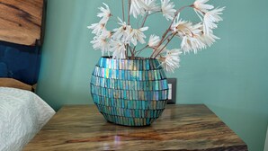 A white dresser with a wooden top and a mosaic vase with white flowers. - Rent a home away from home in front of the Best View of beautiful Samaná Bay! (Samana)