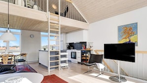 A spacious loft apartment with a mezzanine, a kitchen, a dining area, and a living room. - 5 Star Holiday Home in Lokken (Lokken)