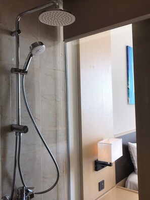 A modern shower with a handheld showerhead and a fixed overhead showerhead, connected by a flexible hose. - Ruby Provided Arena Cam Ranh (Bac Cam Ranh)