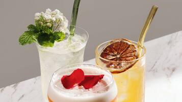 Three cocktails on a marble surface.