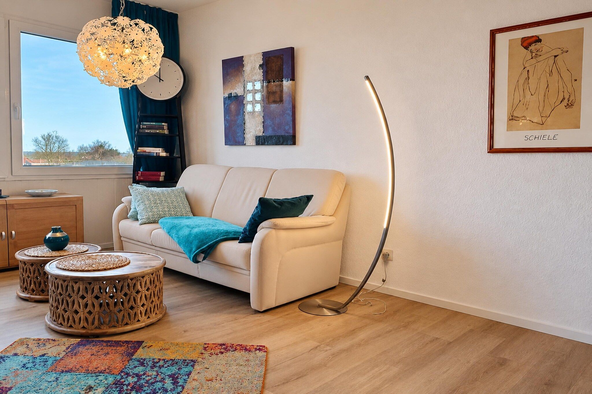 A modern living room with a sofa, coffee table, and floor lamp.