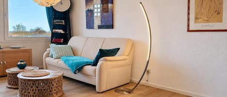 A modern living room with a sofa, coffee table, and floor lamp.