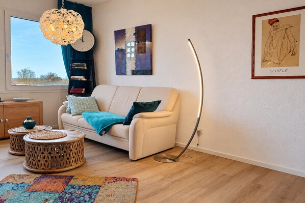 A modern living room with a sofa, coffee table, and floor lamp.