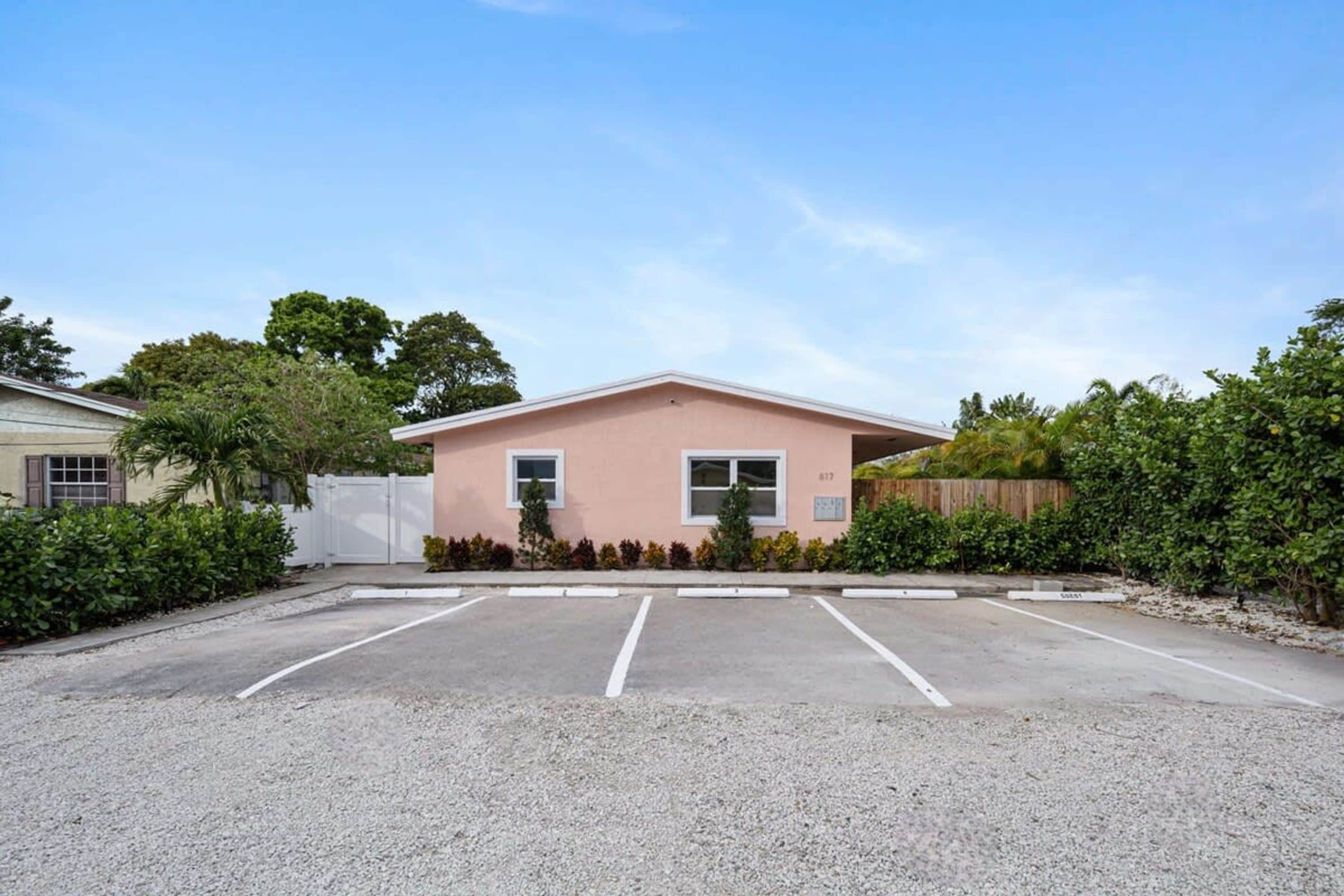 A parking lot with a building in the background.