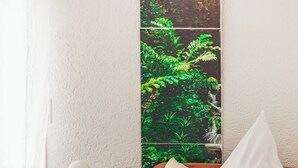 A neatly arranged bedroom with a bed, pillows, a bedside table with a lamp, and a window with a view of greenery. - Platanenweg vacation apartment, perfect for up to 4 people (Alsbach-Hähnlein)