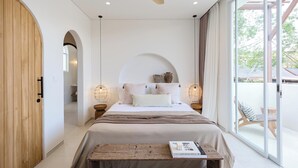 A bedroom with a large bed, wooden wardrobe, arched doorway, and a view of the outside. - New 1BR Private Pool Villa in Bingin, Uluwatu (Bali)
