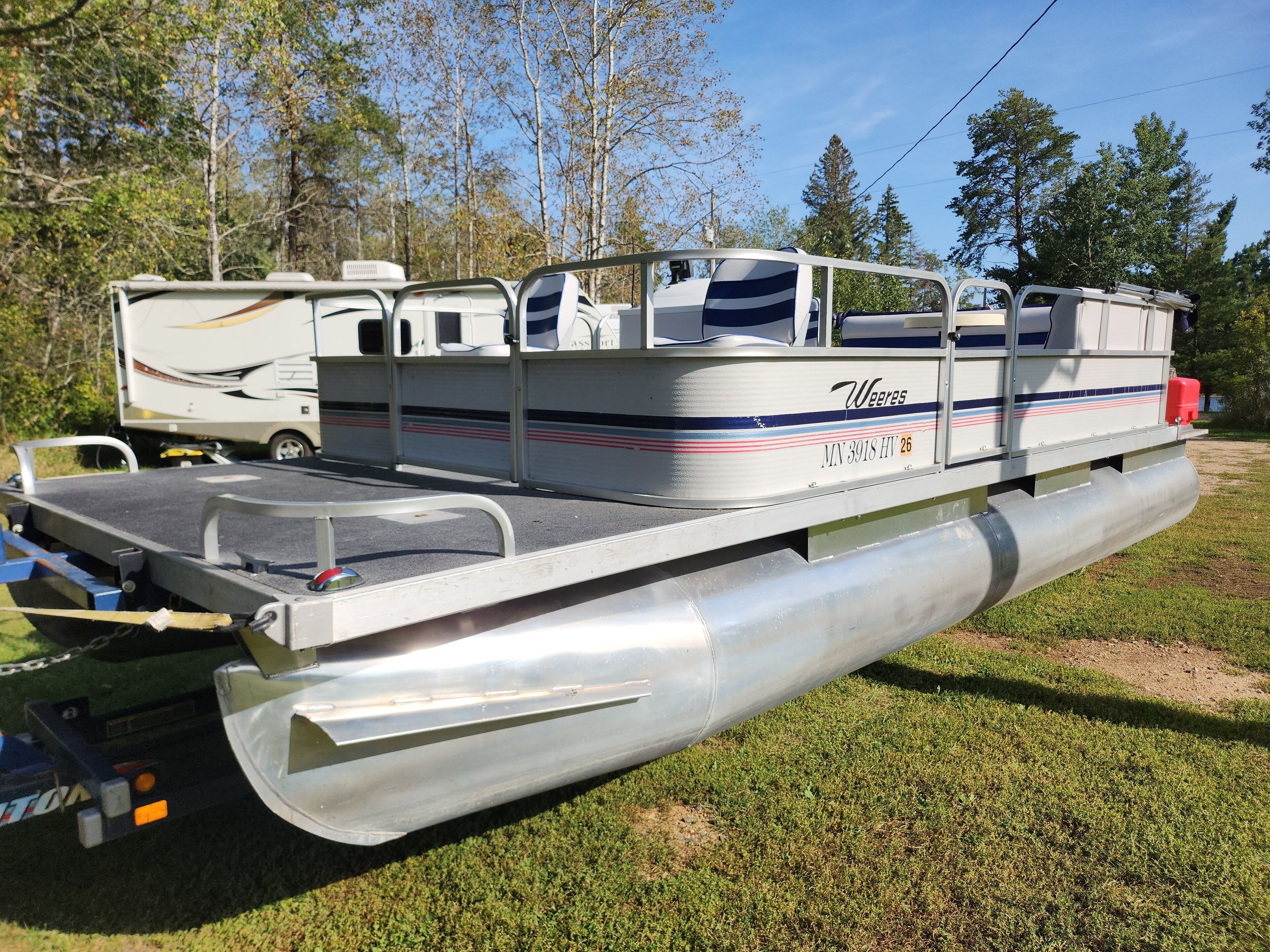A recreational vehicle with a flatbed and a covered seating area.