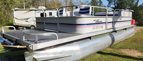 A recreational vehicle with a flatbed and a covered seating area.