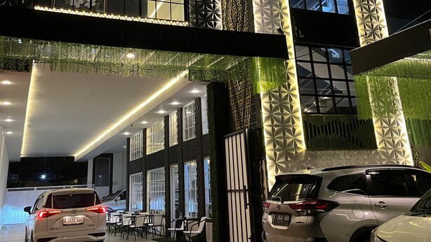 A hotel entrance with a modern design, featuring geometric patterns on the facade and a sign that reads "HOTEL START FROM 200K". - Rafithahotel (Baturetno)