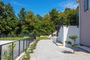 Stroll through the beautifully maintained garden, surrounded by lush greenery and a variety of flowering plants.