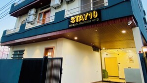 A multi-story building with a sign reading "STAY10 PARALLEL APARTMENT HOTEL". - Stay 10 Parallel Apartment Hotel (Indore)