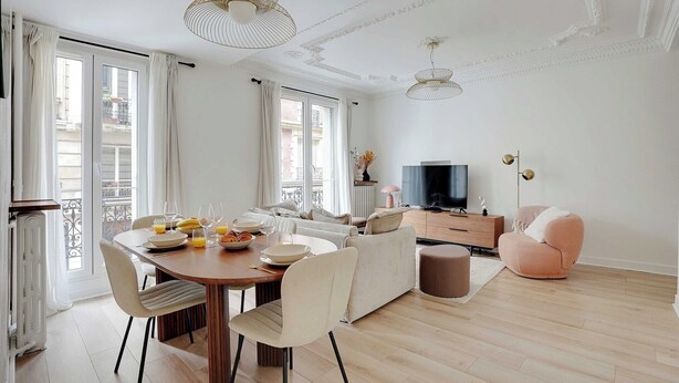 A modern living room with a dining area, a sofa, a TV, and a balcony. - Modern apartment - 2BDR/6P - Paris 14e (Paris)