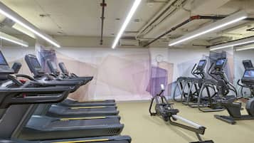 A gym with treadmills, elliptical machines, and a stationary bike.