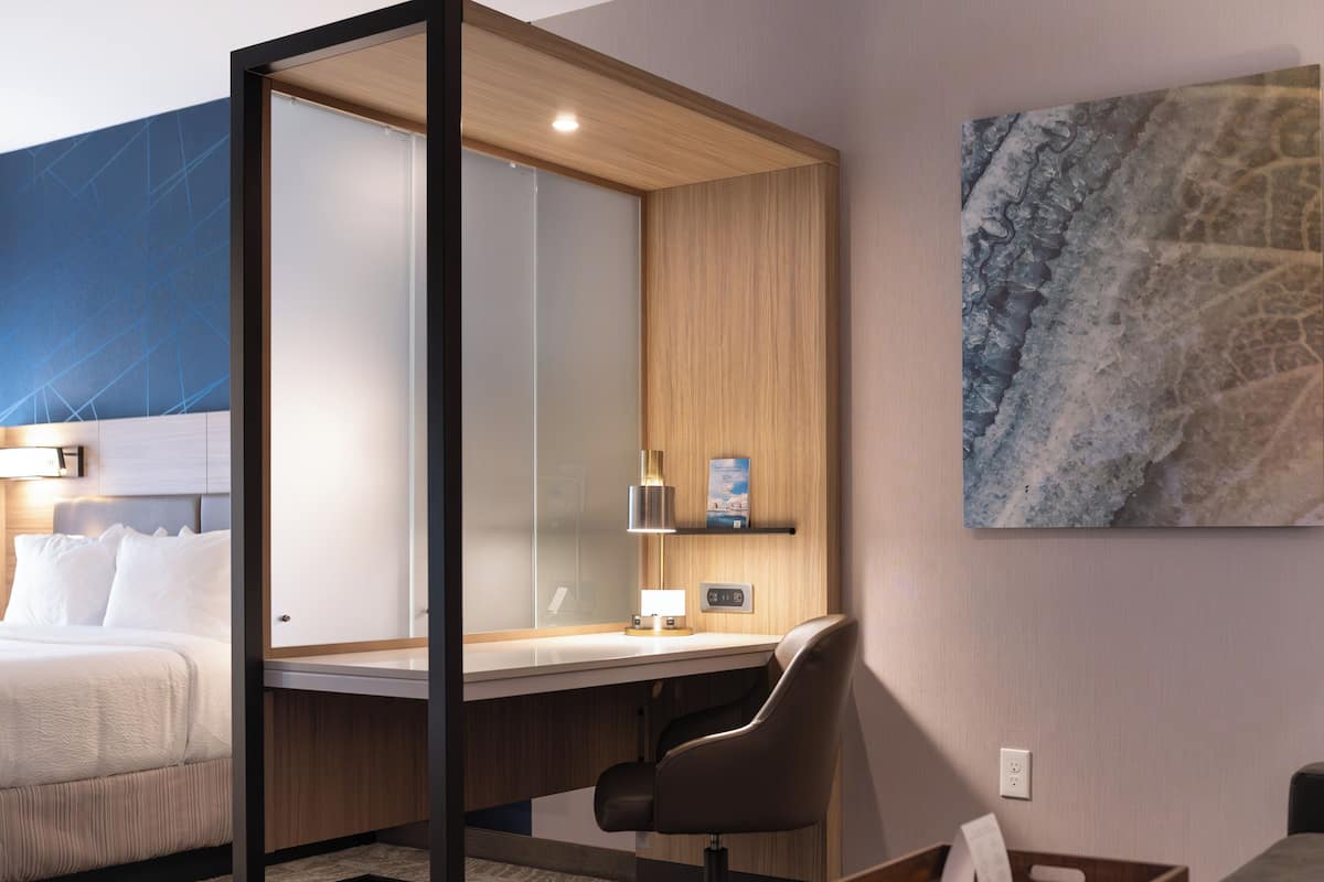 Desk, laptop workspace, blackout drapes, iron/ironing board