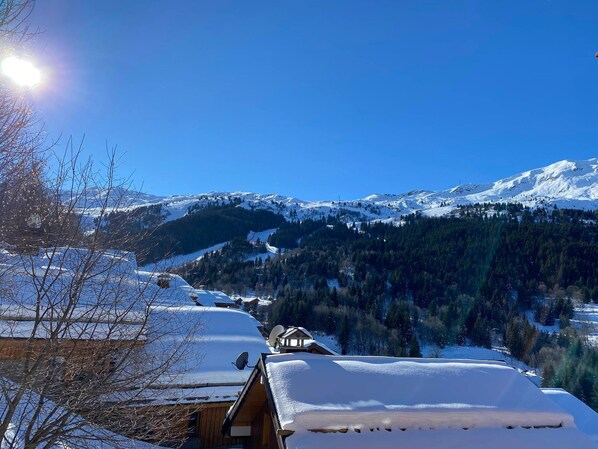 A snow-covered mountain landscape with a clear sky.