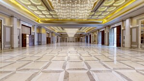 A spacious hallway with a geometric marble floor and a large, ornate chandelier. - The Tivoli New Delhi (New Delhi)