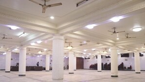 A spacious hall with high ceilings, multiple columns, and ceiling fans. - Hotel Royal Palace Jalandhar (Jalandhar)