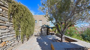 A stone building with a stone pathway leading to a door.