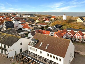 A coastal town with a prominent white building labeled 'Hotel Klitbakken' featuring a covered outdoor seating area. - 5 Star Holiday Home in Lokken (Lokken)