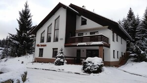 A two-story building with a balcony and a sign that reads "Villa Jensen." - Apartment in Harrachov With Barbecue (Harrachov)