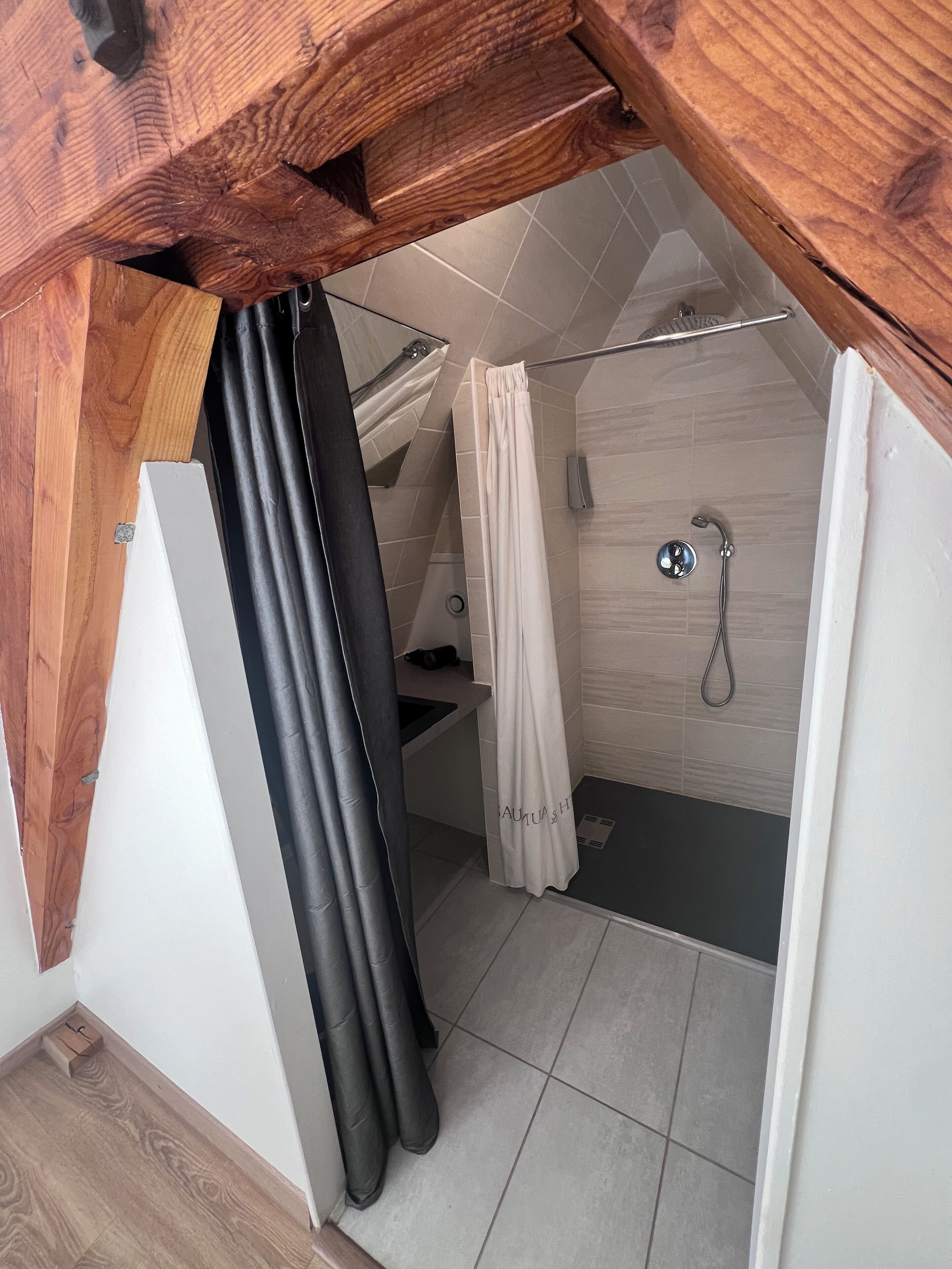 A bathroom with a shower, a toilet, and a sink.