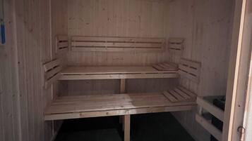 A sauna room with wooden benches and a tiled floor.