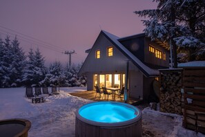 A house with a swimming pool, outdoor seating, and snow-covered surroundings. - Villa in Dolni Branna With Sauna (Dolni Branna)