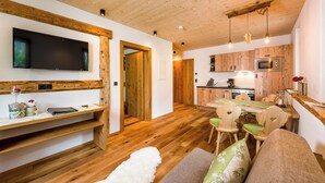 A modern kitchen with wooden cabinets and a built-in microwave. - Erholungswelt Lechrefugium (Steeg)