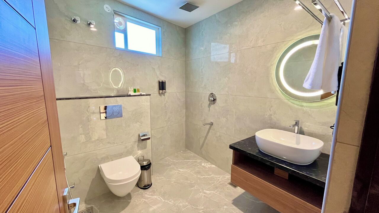 A modern bathroom with a toilet, bidet, and sink.