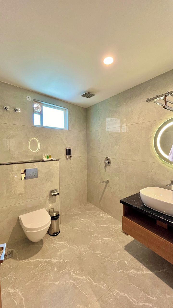 A modern bathroom with a toilet, bidet, and sink.
