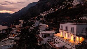 A coastal village with terraced houses, a prominent church, and a waterfront view.
