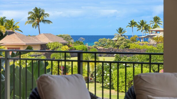 A balcony with a view of the ocean and tropical vegetation. - Kolea 2E -Newly furnished in 2024 3 BR Condo -Hilton Waikoloa Access Included (Waikoloa)