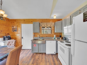 Enjoy cooking in this well-equipped kitchen with a stainless steel sink, oven, and refrigerator.