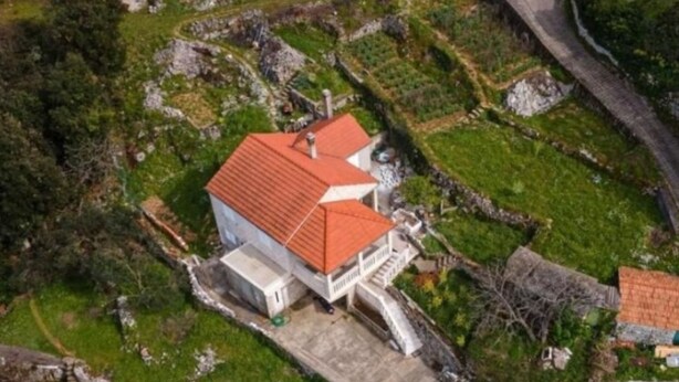 A white building with a red roof, surrounded by green fields and stone walls. - Perfect Getaway Near Korčulas Scenic Sights and Beaches (Korcula)