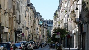 A narrow street lined with historic buildings, parked cars, and street lamps. - A CENTRAL PARISIAN EXPERIENCE WITH MODERN CONVENIENCES IN THE ICONIC LE MARAIS (Paris)