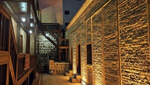 A narrow alleyway with stone walls and wooden railings, leading to a staircase. - Mihman Konak Hotel (Kars)