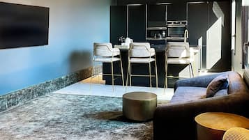 Premium Apartment, 2 Bedrooms | Living room | 70-inch flat-screen TV with cable channels