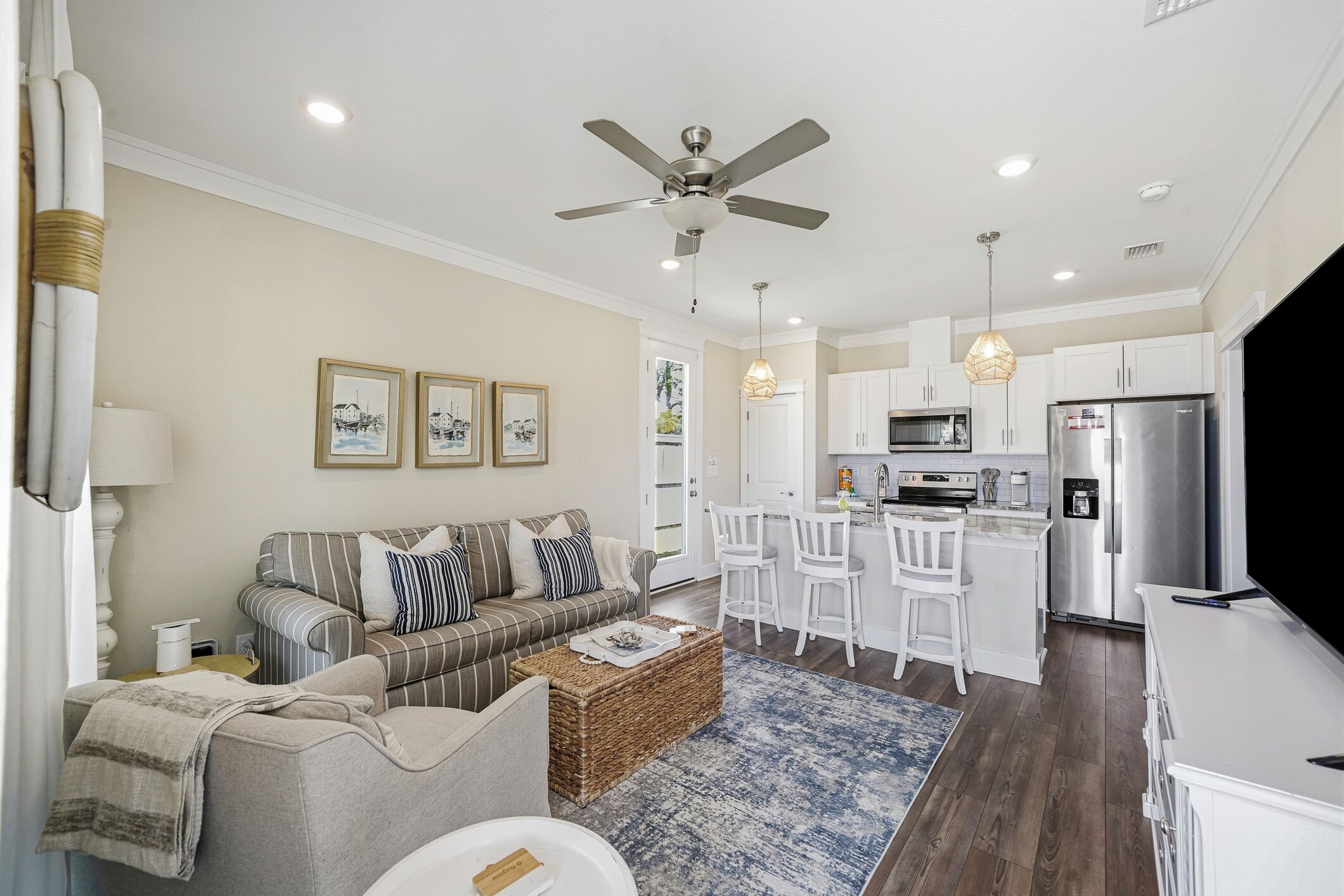 A modern living room with a sofa, a coffee table, and a ceiling fan.