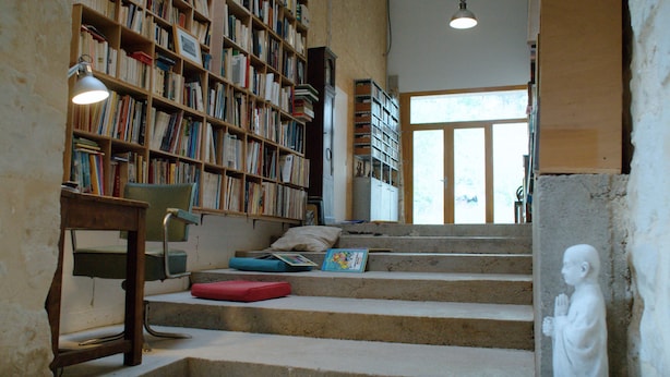 A library with bookshelves, a desk, a chair, and a statue. - Théveny, Le Levant (Saint-Astier)