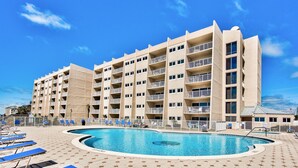 A hotel with multiple floors, a swimming pool, and sun loungers. - Stunning BH 301A w/Seasonal Beach Service (Miramar Beach)