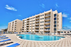 A hotel with multiple floors, a swimming pool, and sun loungers. - Stunning BH 301A w/Seasonal Beach Service (Miramar Beach)