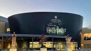 A building with a sign for Warner Bros. Studio Tour London - The Making of Harry Potter.