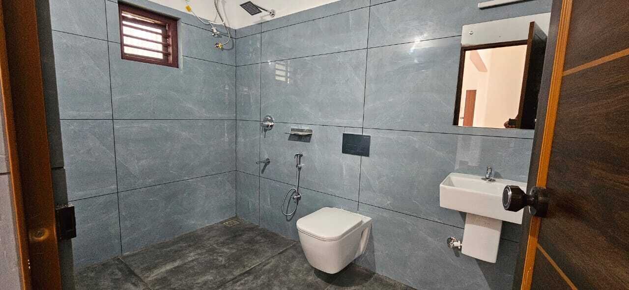 Une salle de bain comprenant des toilettes, un lavabo et un espace douche.