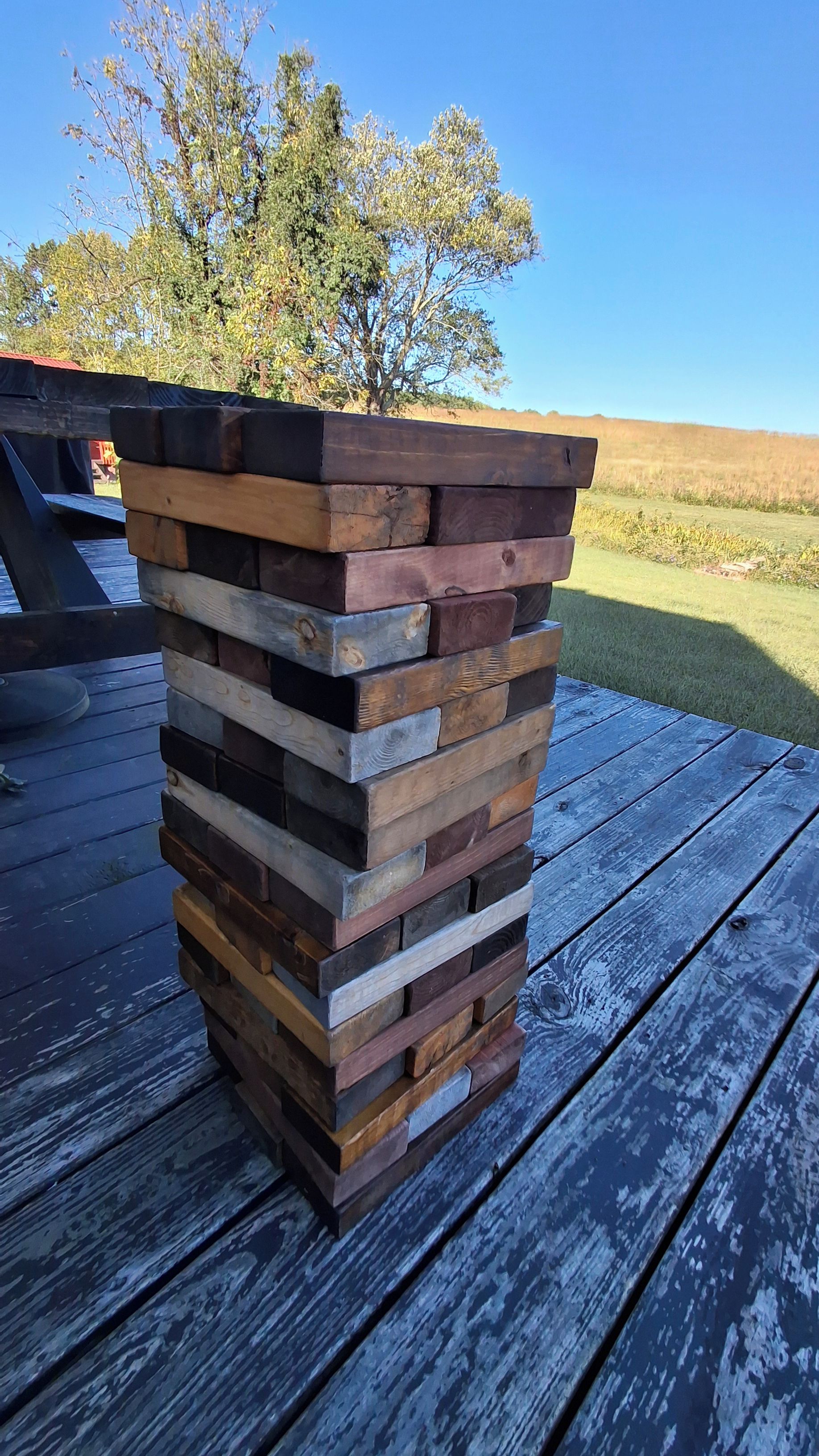 A stack of wooden planks on a wooden deck.