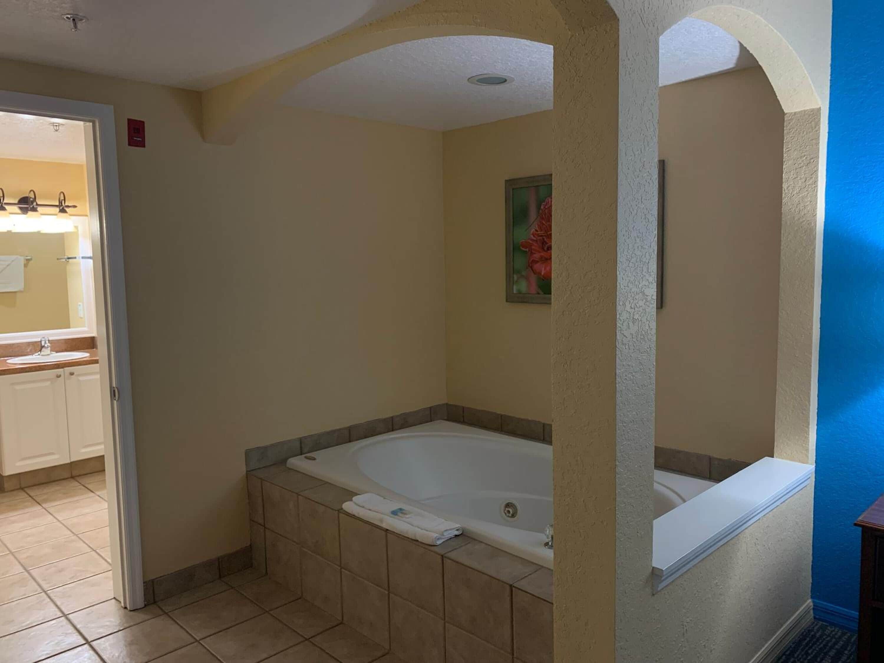 A bathroom with a bathtub, a shower, and a sink.