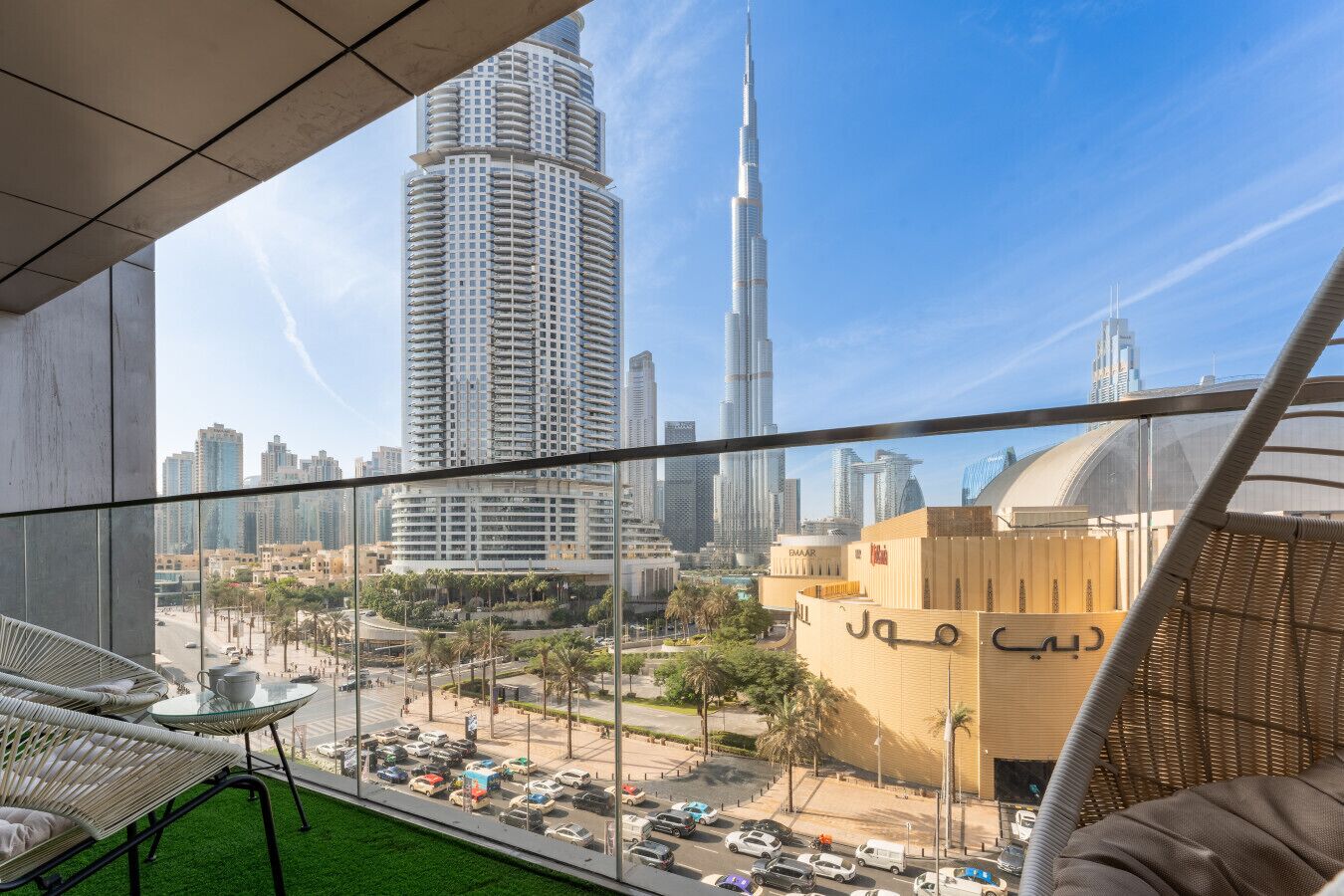 A balcony with a view of the Burj Khalifa and surrounding buildings.