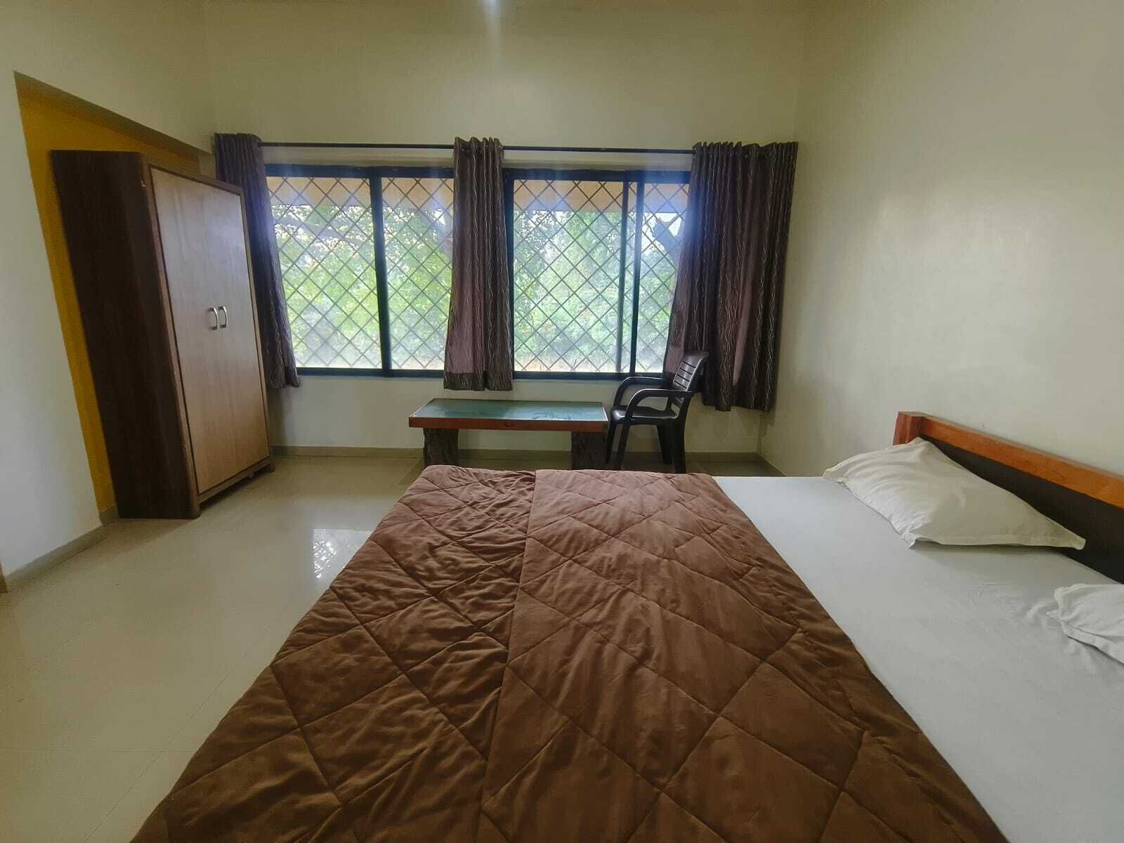 A room with a bed, a desk, and a chair.