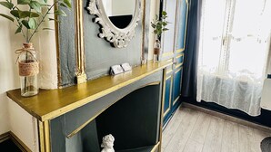 A room with a fireplace, a mirror, and a window with curtains. - Studio Royal (Saint-Omer)
