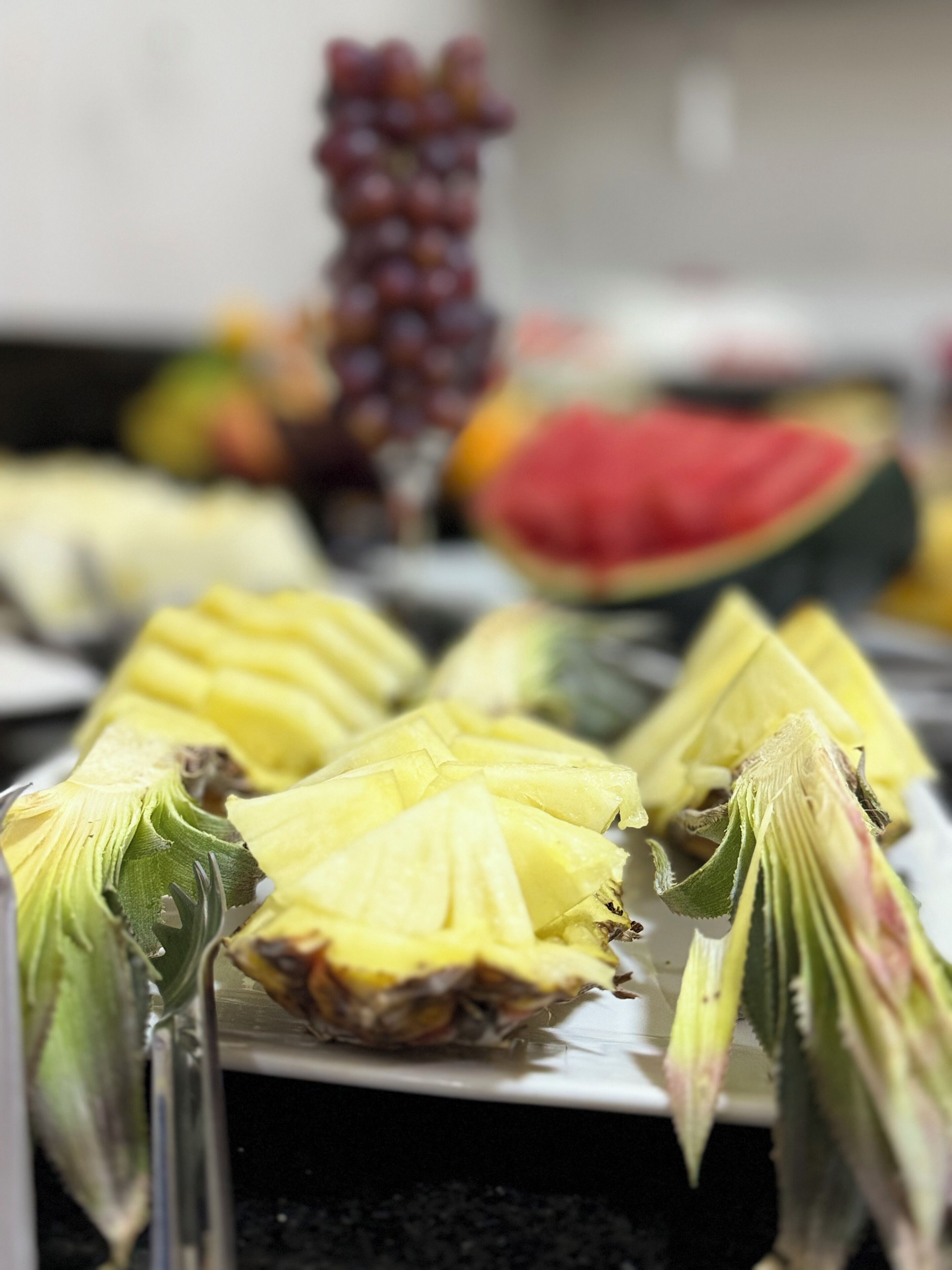 A fruit platter with pineapple and watermelon slices.
